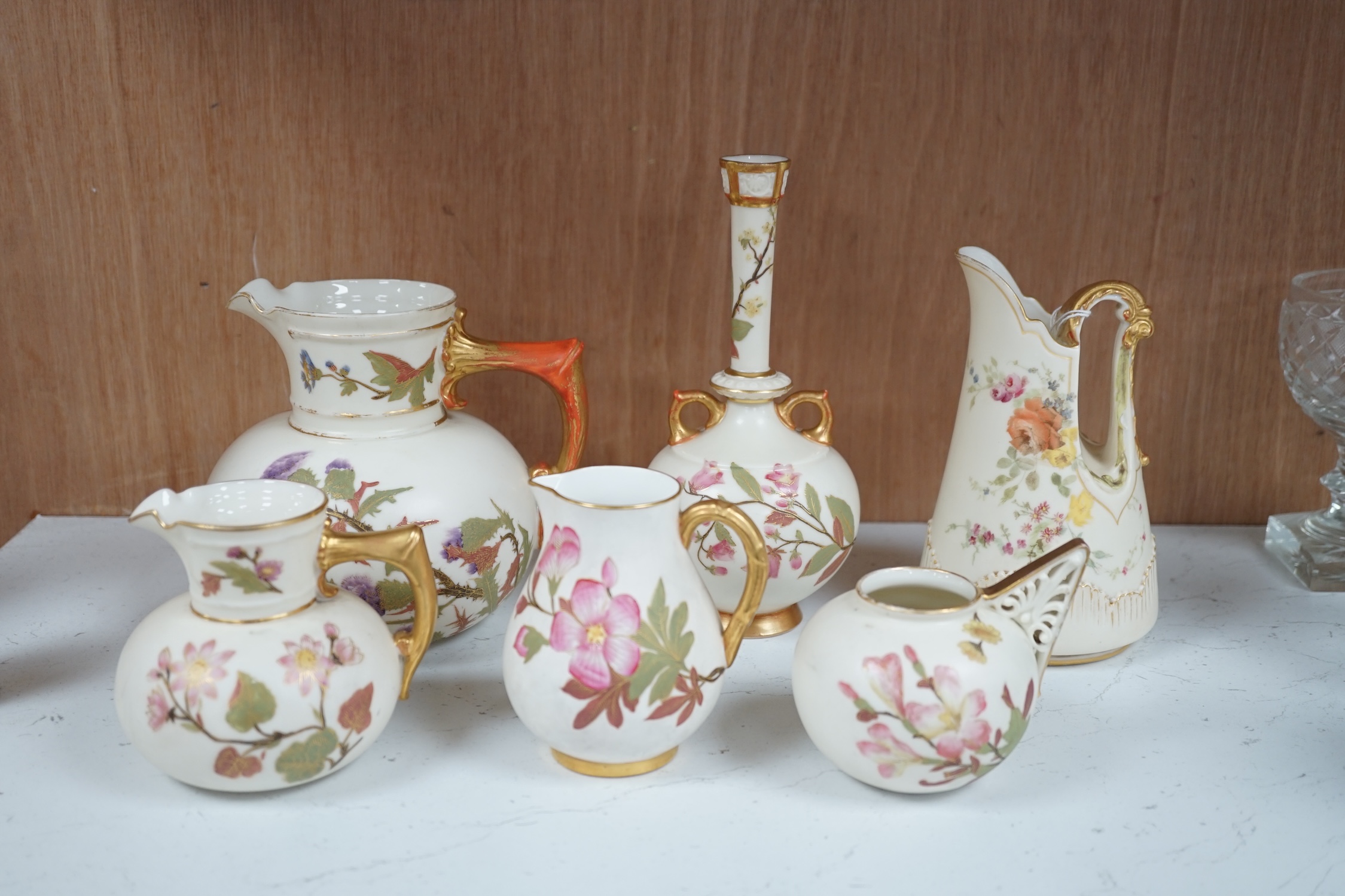 Four Royal Worcester ivory ground and gilt decorated vases and a handled posy pot and tall stemmed vase, 18.5cm high. Condition - some gilt decoration worn